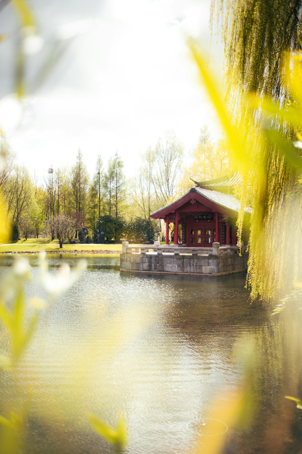 brown wooden house near river during daytime