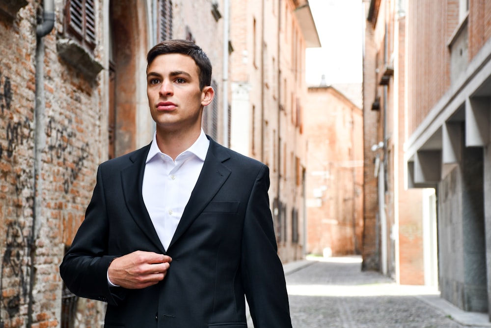 man in black suit jacket and blue necktie