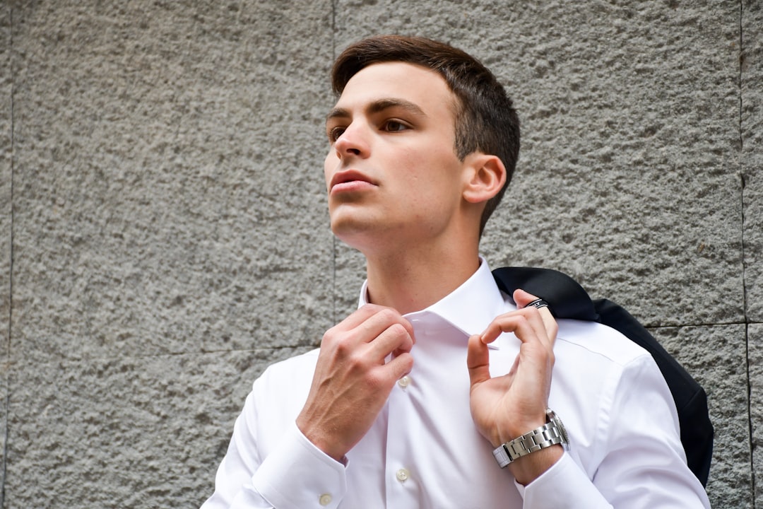 man in white dress shirt and blue necktie