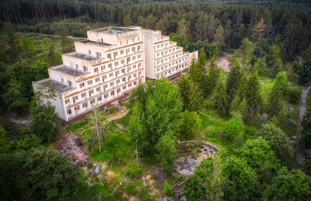 white concrete building surrounded by green trees during daytime