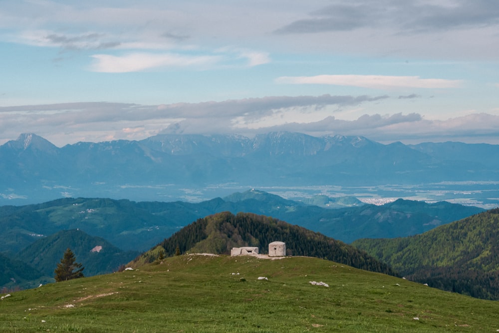 green grass field and mountains during daytime