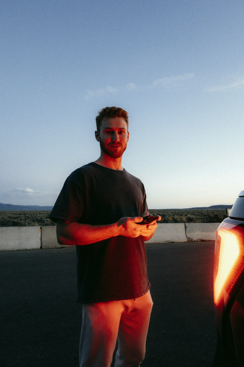 man in black crew neck t-shirt holding black and white toy gun