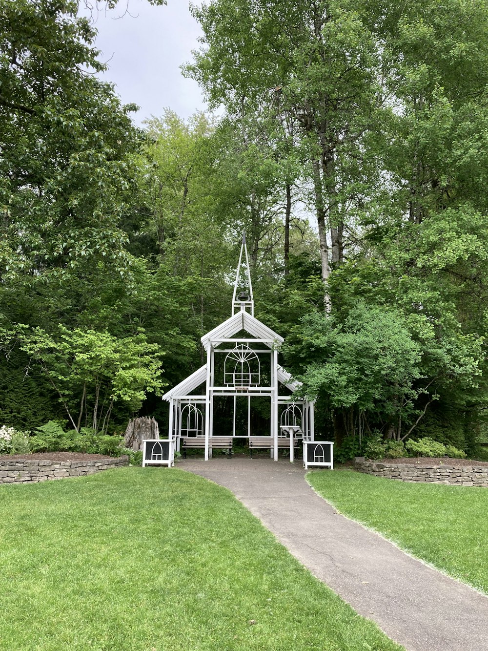 white wooden house surrounded by green trees during daytime