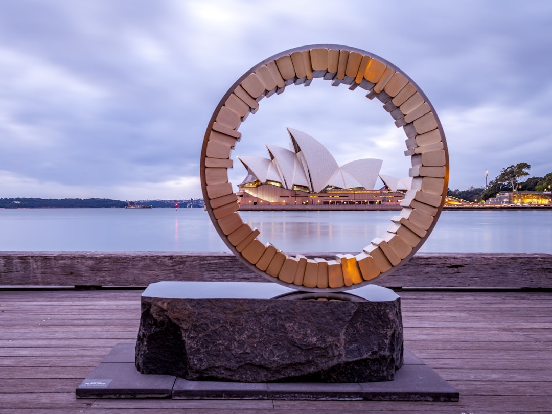 brown wooden round table near body of water during daytime