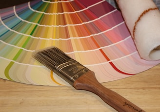 brown paint brush on white and red plaid textile