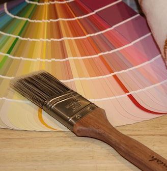 brown paint brush on white and red plaid textile