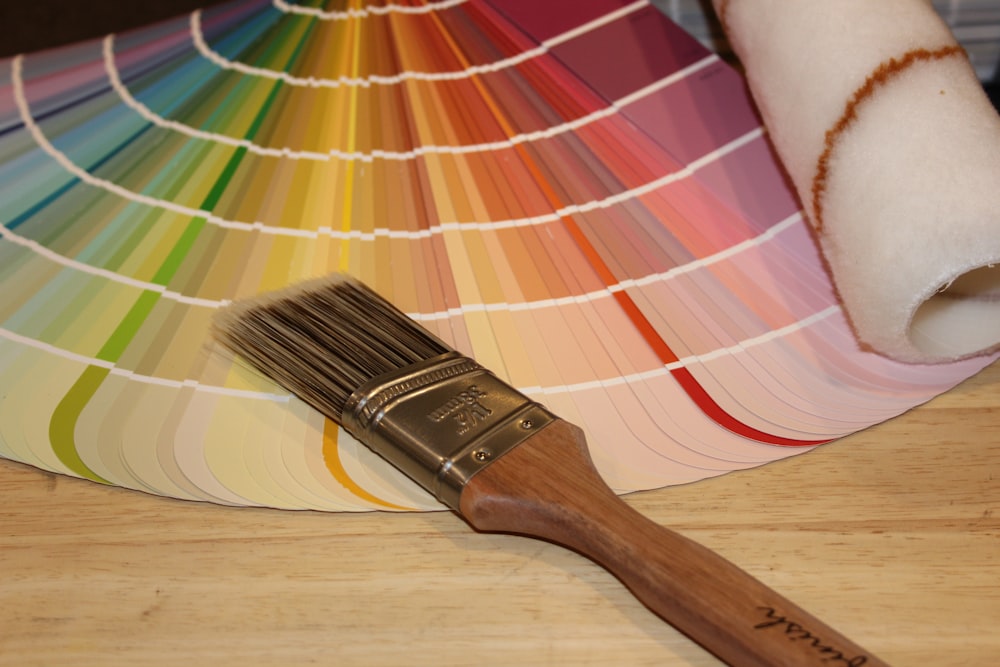 brown paint brush on white and red plaid textile