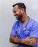 man in blue scrub suit wearing blue stethoscope