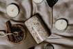 A collection of soothing wellness items like candles, journals, and herbal teas arranged invitingly.