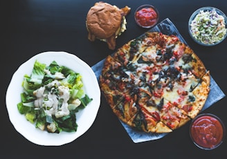 pizza with green vegetable on white ceramic plate