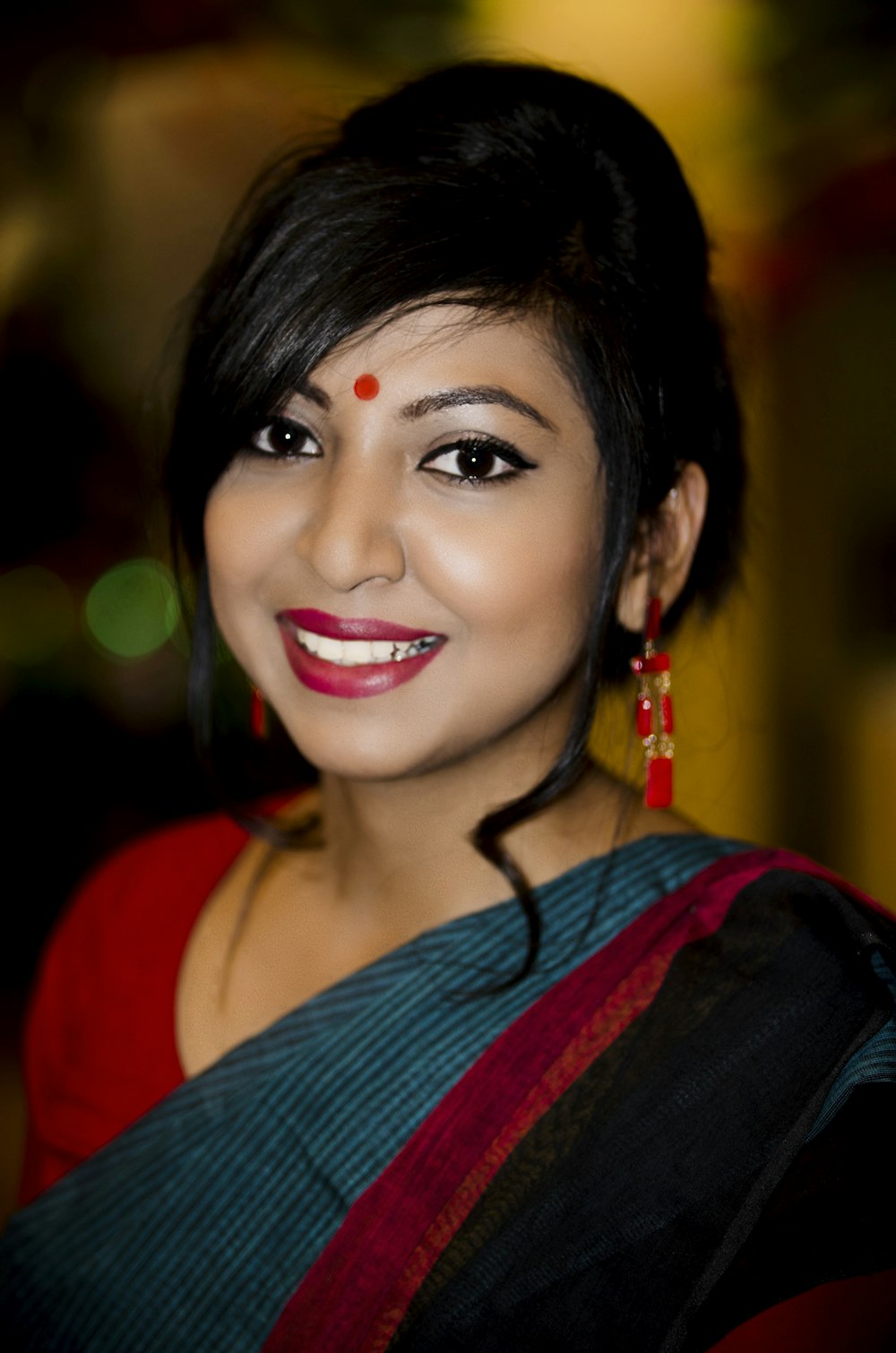 woman in red and blue shirt smiling