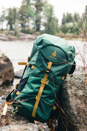 green and brown backpack on rock