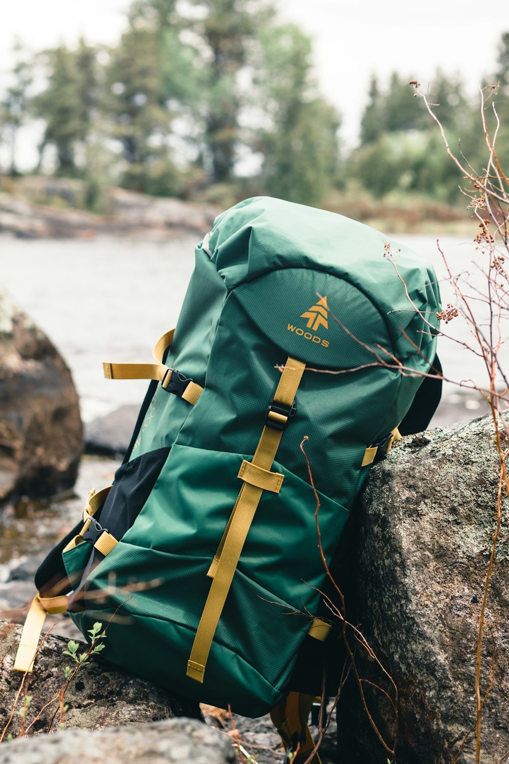 green and brown backpack on rock