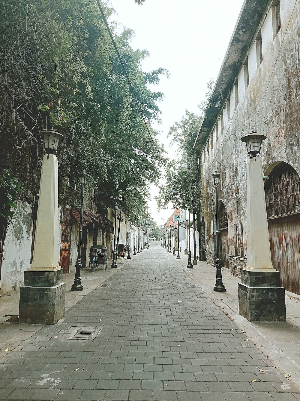 people walking on sidewalk between buildings during daytime