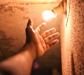 person holding lighted ball during night time