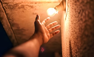 person holding lighted ball during night time