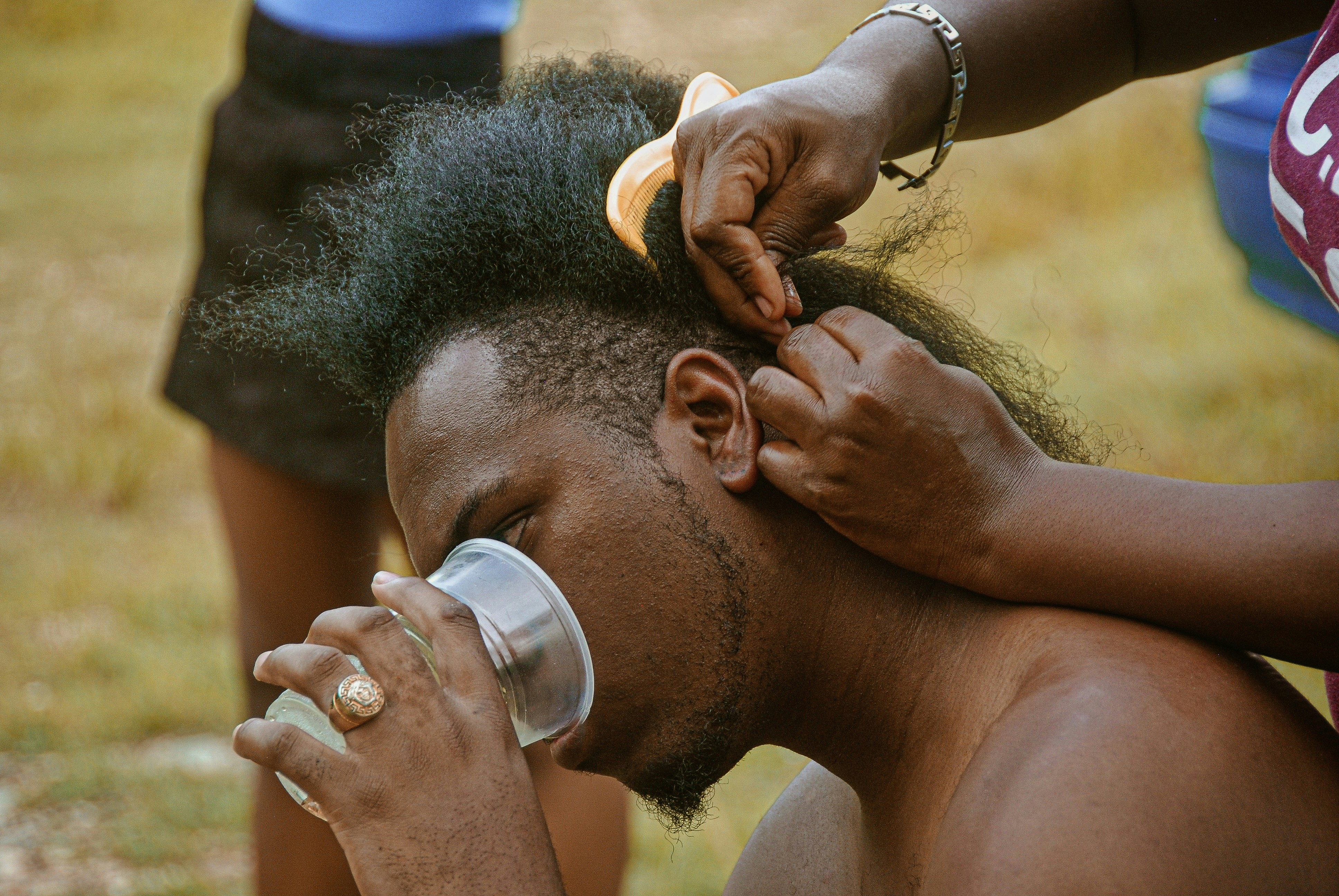 Person applying shea butter to hair