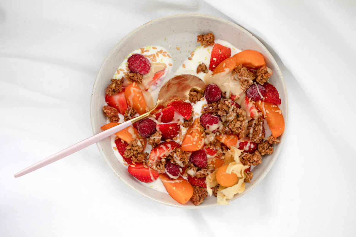 A breakfast bowl topped with seeds and fresh fruit