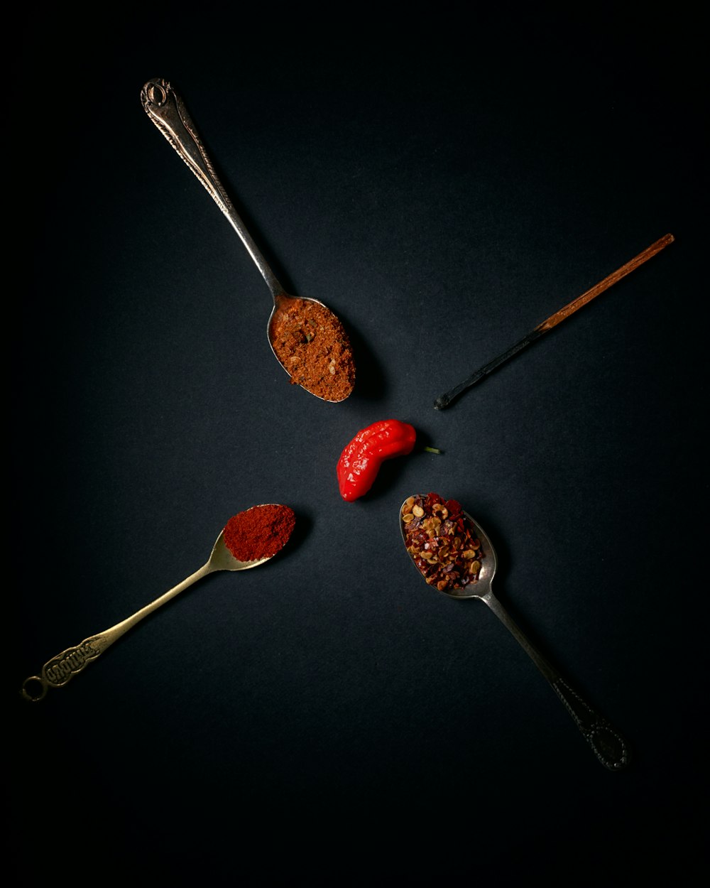 three stainless steel spoons with red and brown fruits
