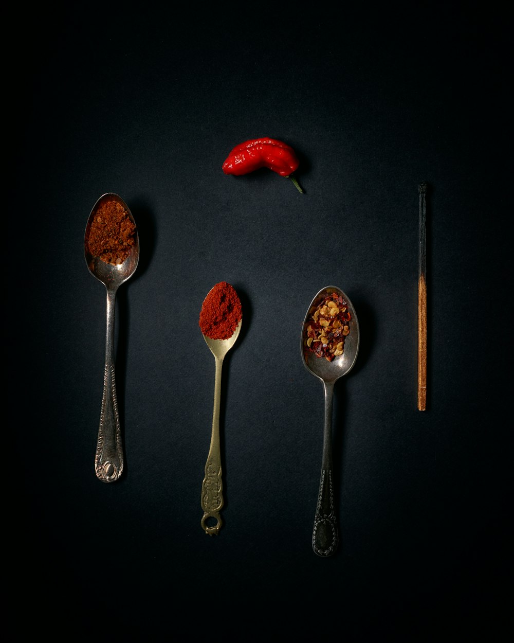 stainless steel spoons with red and brown liquid