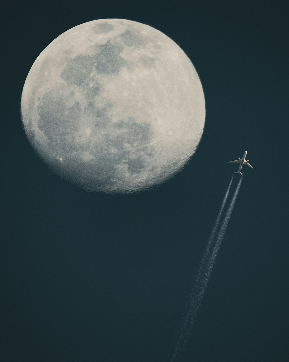 white and blue moon with black background