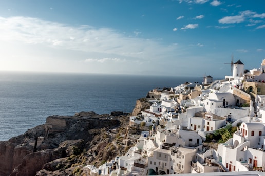 white concrete houses near sea under blue sky during daytime