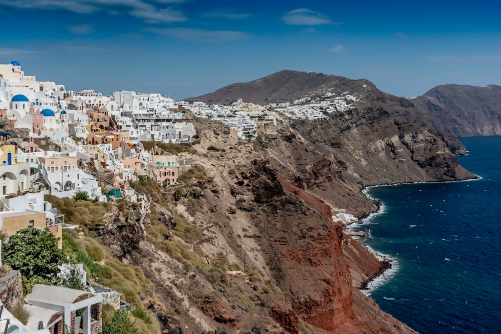 white and brown concrete buildings near body of water during daytime