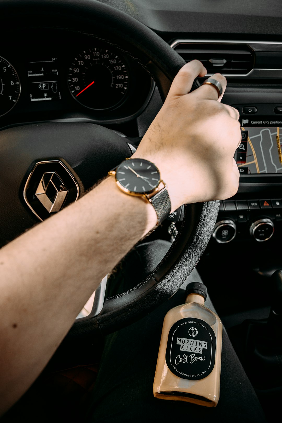 person wearing gold and black analog watch