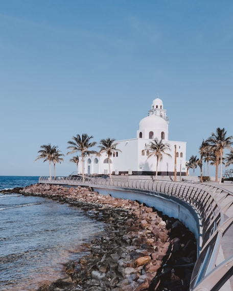 white concrete building near body of water during daytime