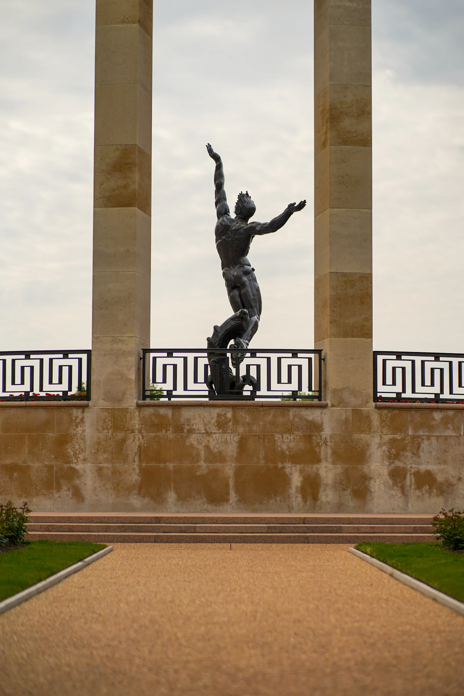Bronze statue silhouetted at the Normandy American Cemetery in Colleville-sur-Mer, France, overlooking Omaha Beach