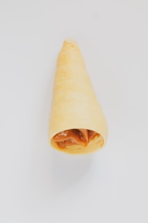 An elegant close-up of a chocolate cone drizzled with caramel.