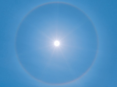 blue sky with white sun