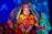 A beautifully adorned Hindu deity statue with intricate jewelry, floral garlands, and a vibrant red saree. The statue has a serene expression, surrounded by a colorful backdrop with blue stars. The hands are posed in symbolic gestures.