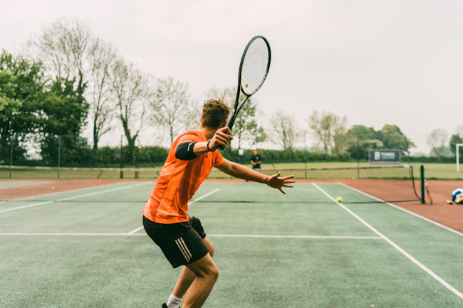 Tennis ball resting on a court