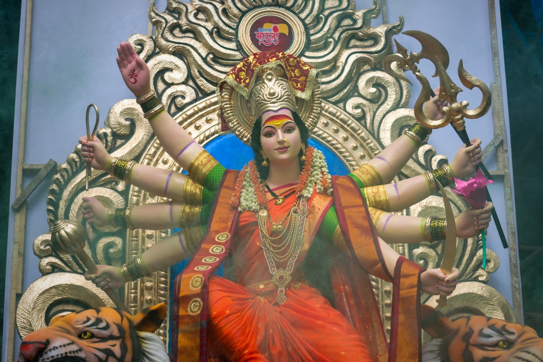 woman in red and gold dress statue, A beautiful idol of Maa Durga at a workshop in Mumbai during Navratri 2019