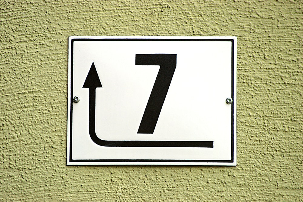 white and black arrow sign
