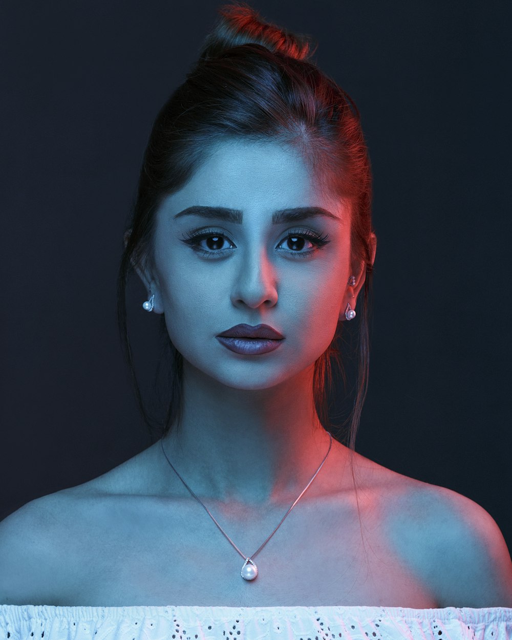 woman in silver necklace with red lipstick