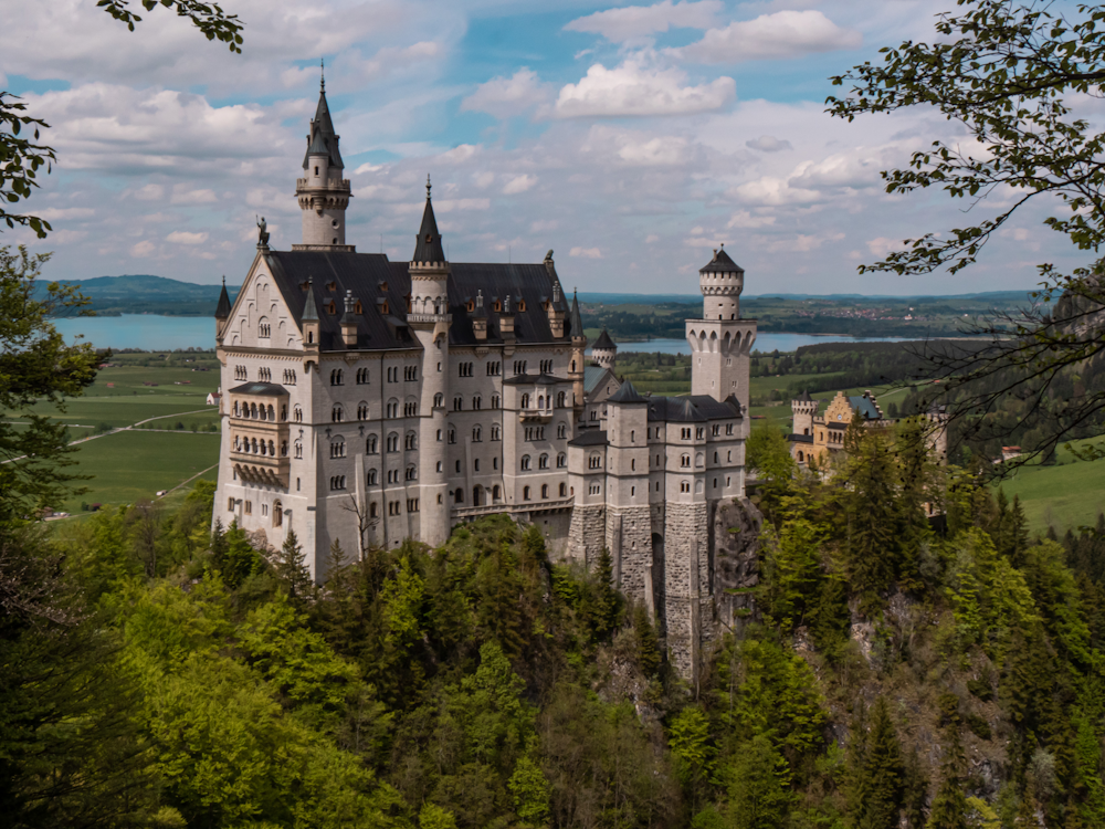 white and blue castle on top of hill