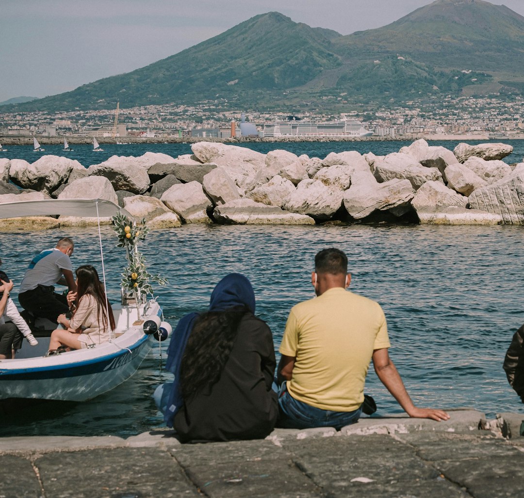 man and woman sitting on blue and white boat on sea during daytime