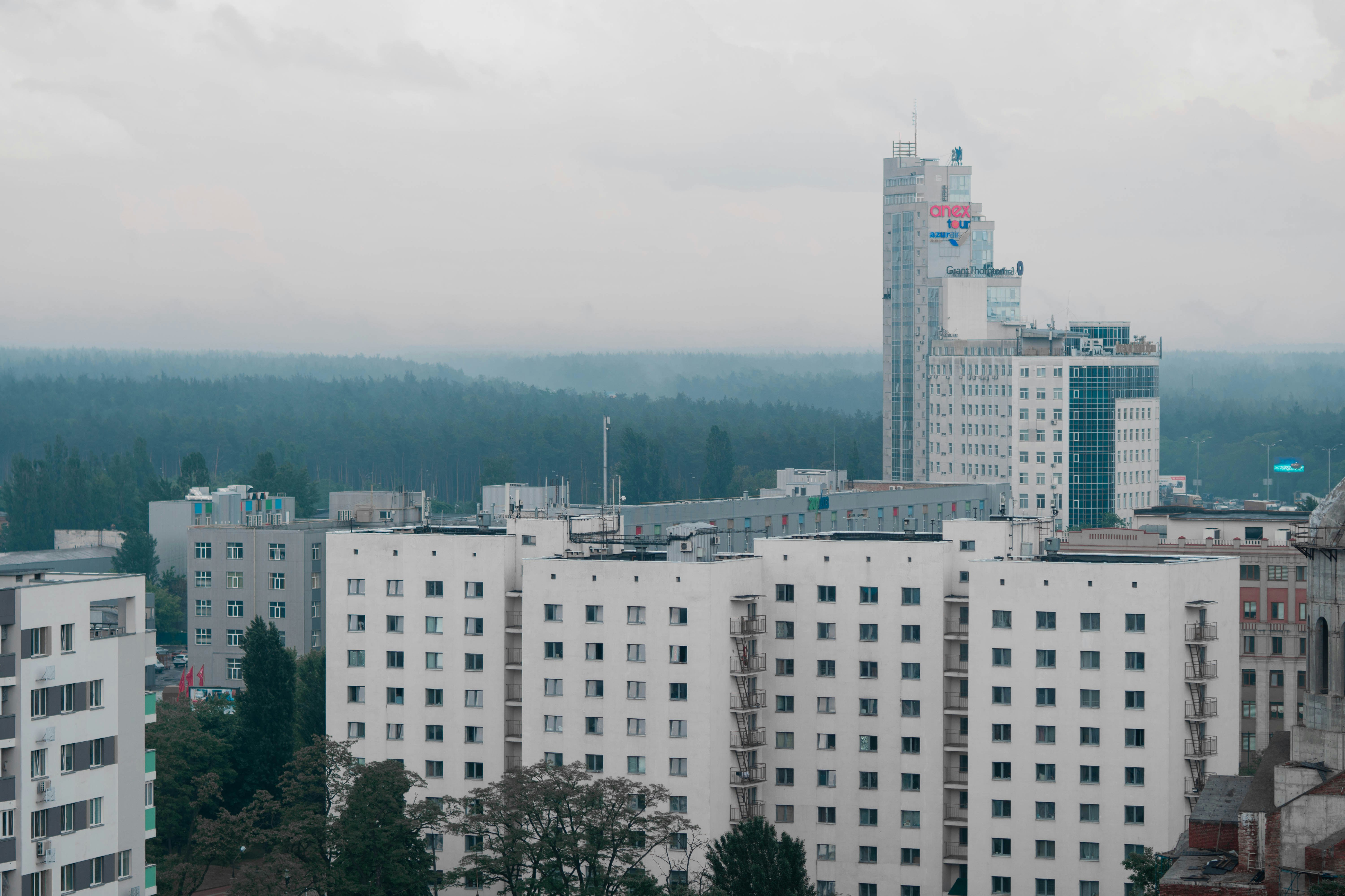 white concrete building near green trees during daytime