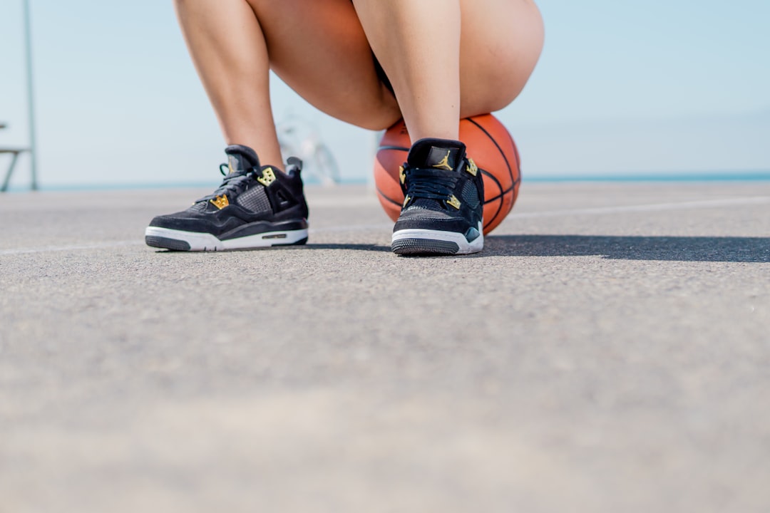 person in black and white nike sneakers