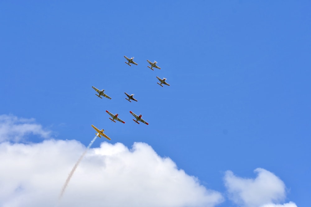 four fighter planes in mid air under blue sky during daytime