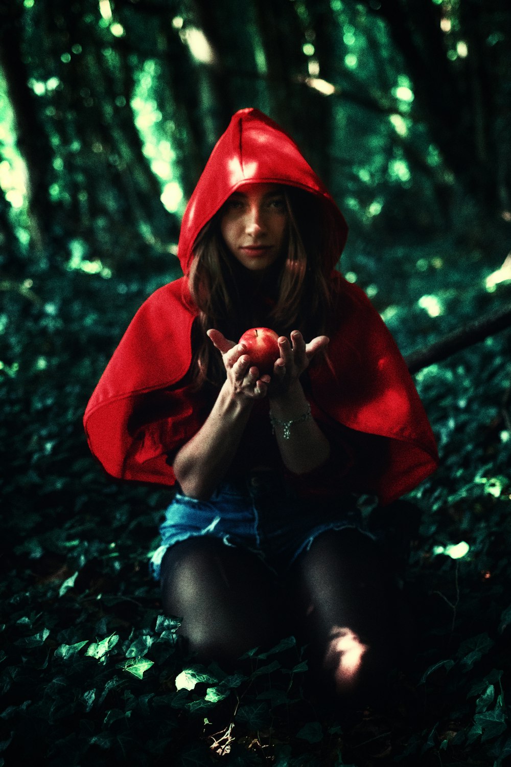 woman in red hoodie sitting on ground