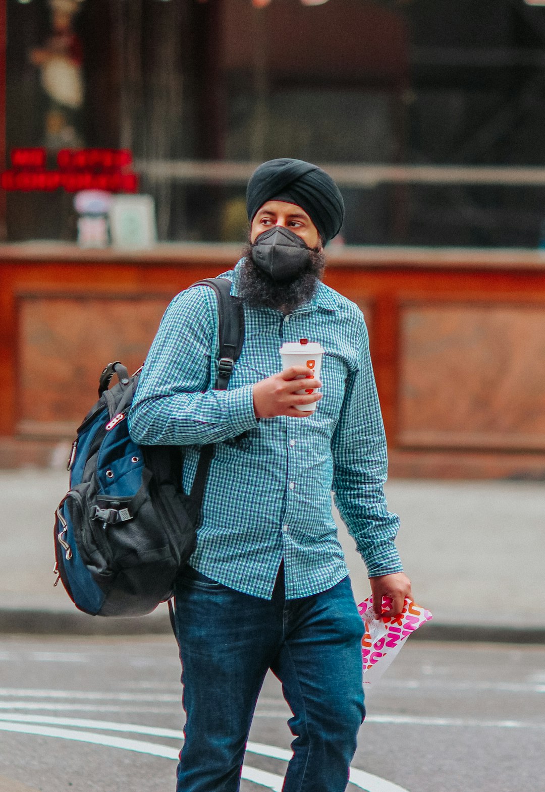 man in gray sweater carrying black backpack