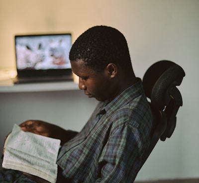 man in black and white plaid dress shirt sitting on black office rolling chair