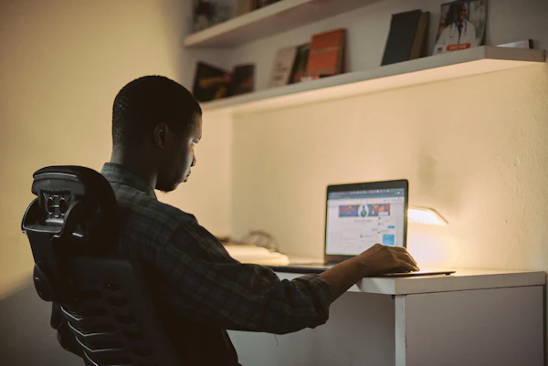 Creative African man working focused at his computer in Nigeria — built around your schedule