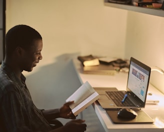 man in black dress shirt using laptop computer
