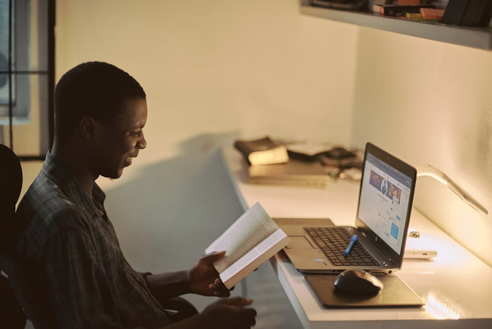 man in black dress shirt using laptop computer