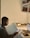 A student studying with a laptop in a cozy environment.
