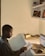 A person reading customer reviews on a laptop in a cozy setting.